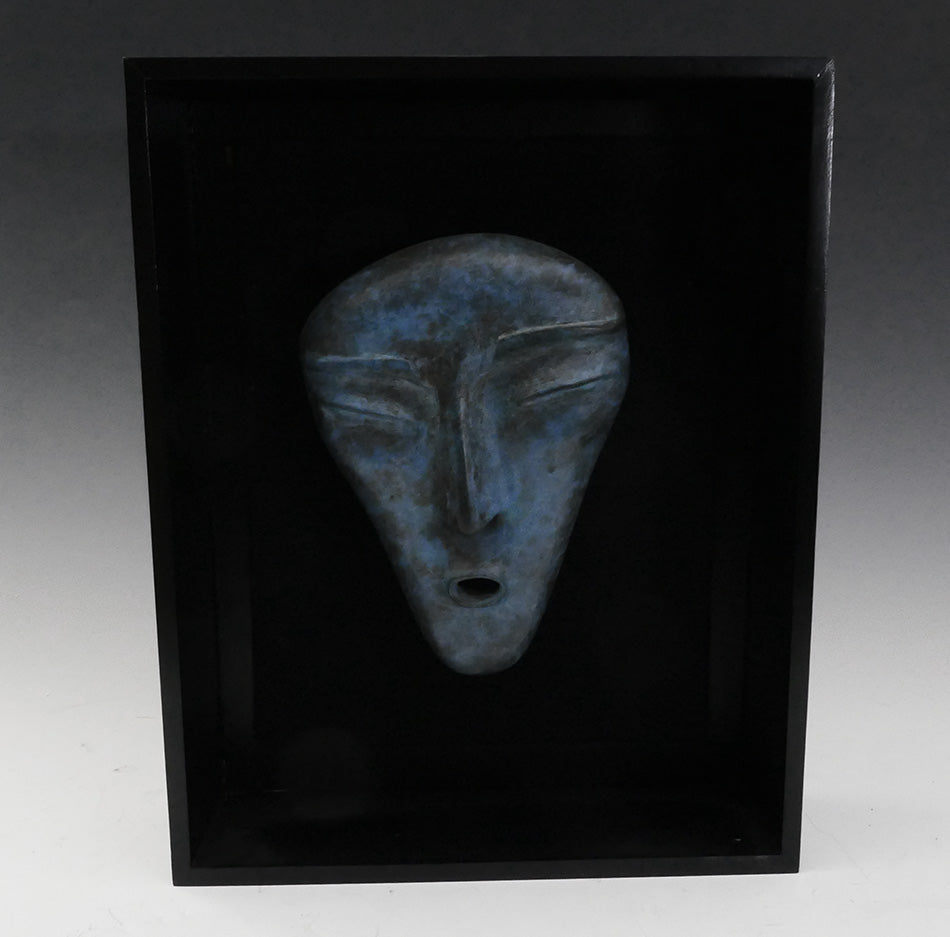 Three bronze faces by David Ruben Piktouqun Inuit sculpture