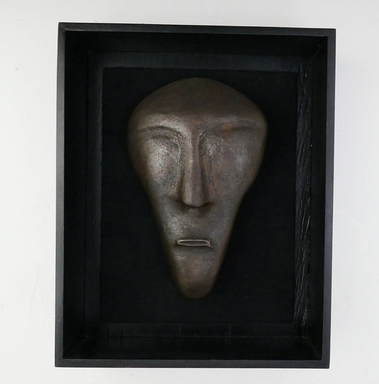 Three bronze faces by David Ruben Piktouqun