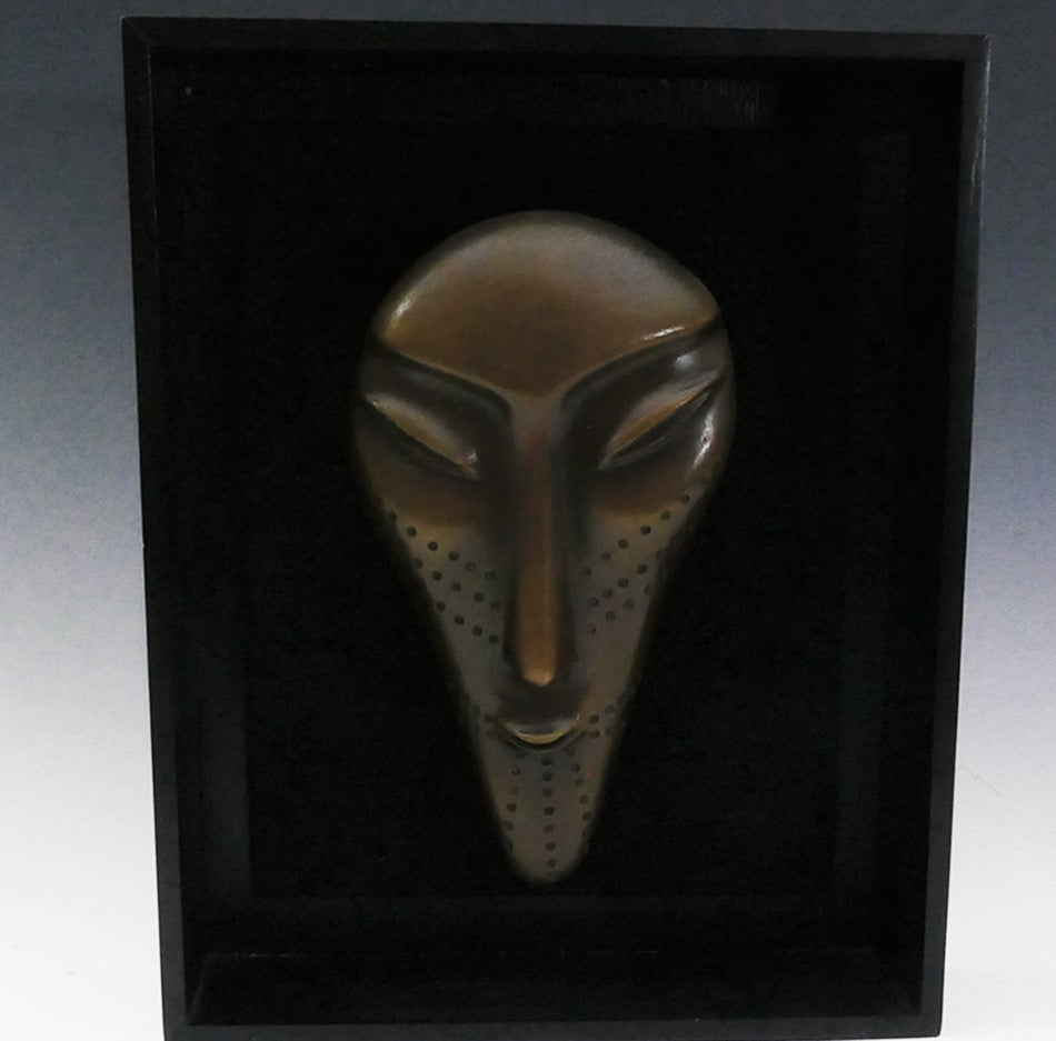 Three bronze faces by David Ruben Piktouqun Inuit sculpture