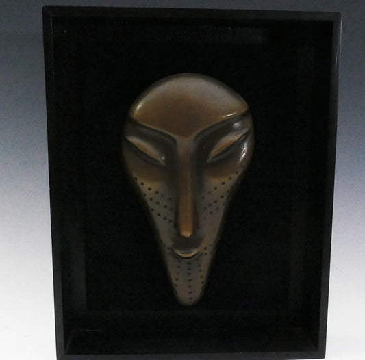 Three bronze faces by David Ruben Piktouqun Inuit sculpture